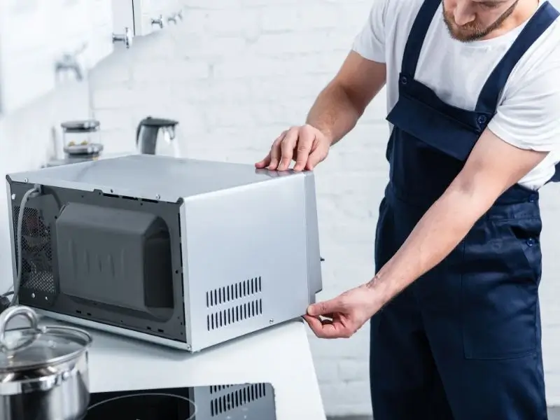 Microwave repair near me – expert technician fixing microwave oven
